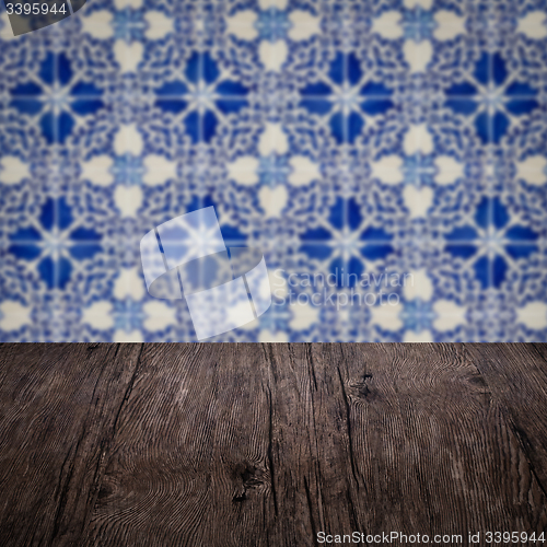 Image of Wood table top and blur vintage ceramic tile pattern wall