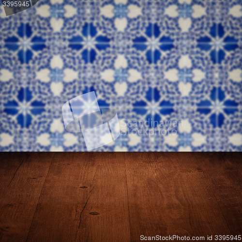 Image of Wood table top and blur vintage ceramic tile pattern wall