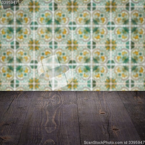 Image of Wood table top and blur vintage ceramic tile pattern wall
