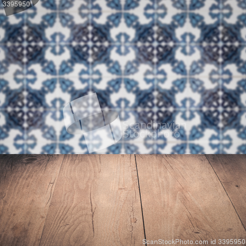 Image of Wood table top and blur vintage ceramic tile pattern wall