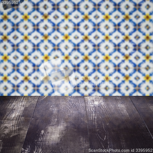 Image of Wood table top and blur vintage ceramic tile pattern wall