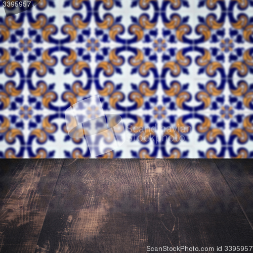 Image of Wood table top and blur vintage ceramic tile pattern wall
