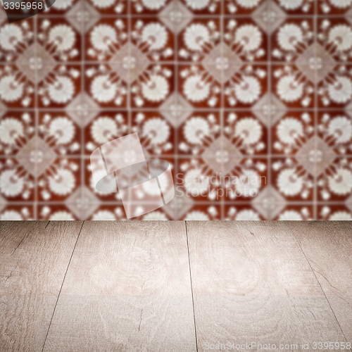 Image of Wood table top and blur vintage ceramic tile pattern wall