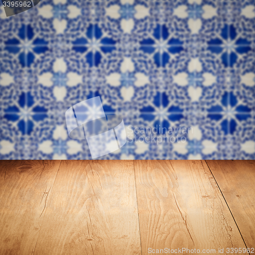 Image of Wood table top and blur vintage ceramic tile pattern wall