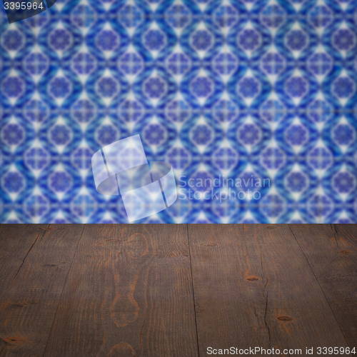 Image of Wood table top and blur vintage ceramic tile pattern wall