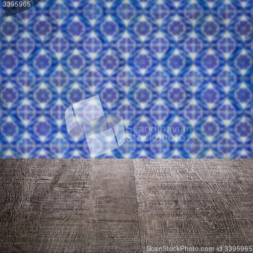 Image of Wood table top and blur vintage ceramic tile pattern wall