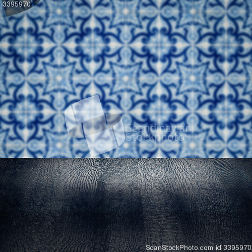 Image of Wood table top and blur vintage ceramic tile pattern wall