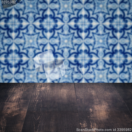 Image of Wood table top and blur vintage ceramic tile pattern wall