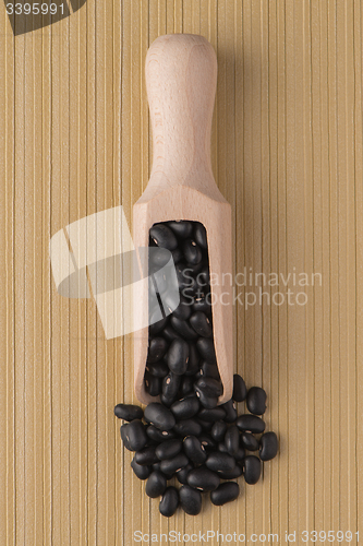 Image of Wooden scoop with black beans