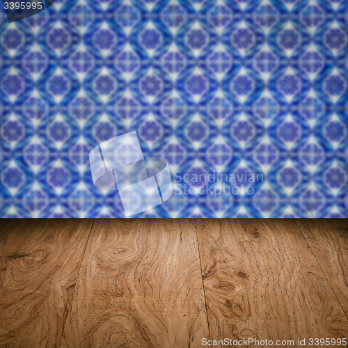 Image of Wood table top and blur vintage ceramic tile pattern wall