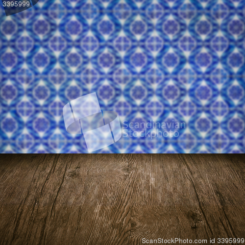 Image of Wood table top and blur vintage ceramic tile pattern wall