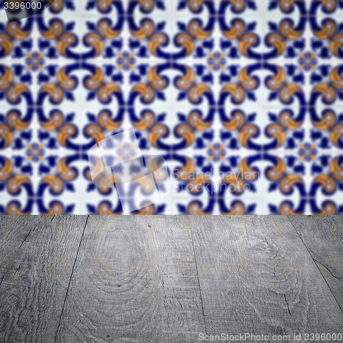 Image of Wood table top and blur vintage ceramic tile pattern wall
