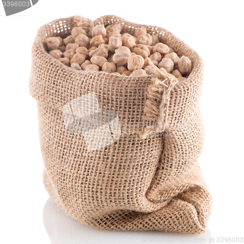 Image of Uncooked chickpeas on burlap bag