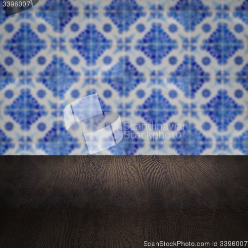 Image of Wood table top and blur vintage ceramic tile pattern wall