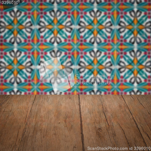 Image of Wood table top and blur vintage ceramic tile pattern wall
