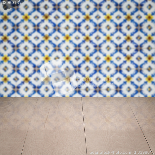 Image of Wood table top and blur vintage ceramic tile pattern wall