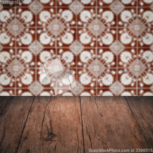 Image of Wood table top and blur vintage ceramic tile pattern wall