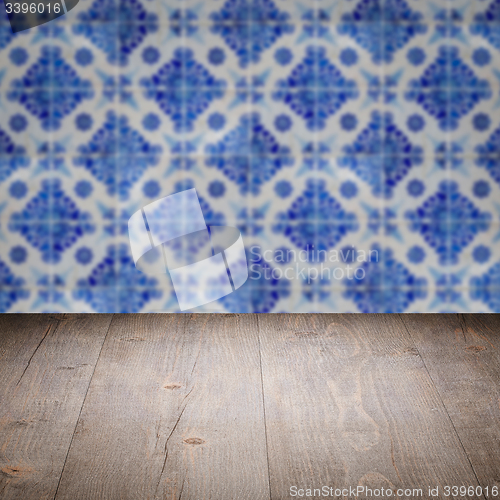 Image of Wood table top and blur vintage ceramic tile pattern wall