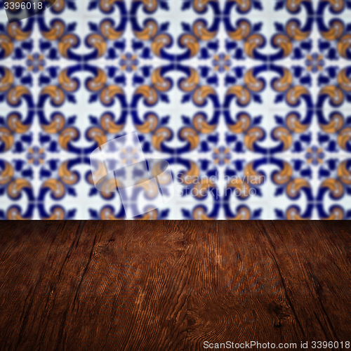 Image of Wood table top and blur vintage ceramic tile pattern wall