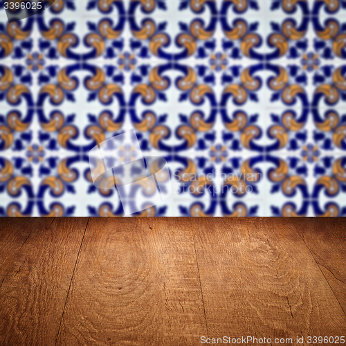 Image of Wood table top and blur vintage ceramic tile pattern wall