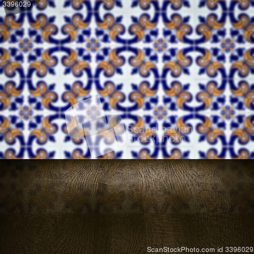 Image of Wood table top and blur vintage ceramic tile pattern wall