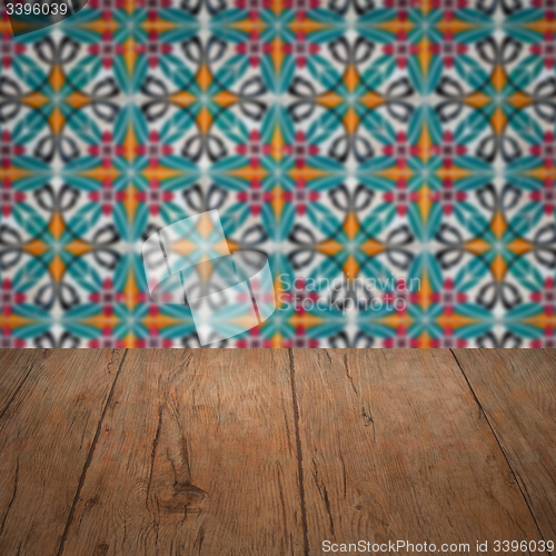 Image of Wood table top and blur vintage ceramic tile pattern wall
