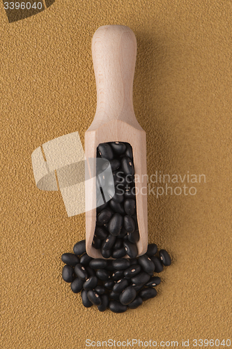 Image of Wooden scoop with black beans