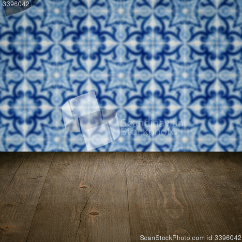 Image of Wood table top and blur vintage ceramic tile pattern wall