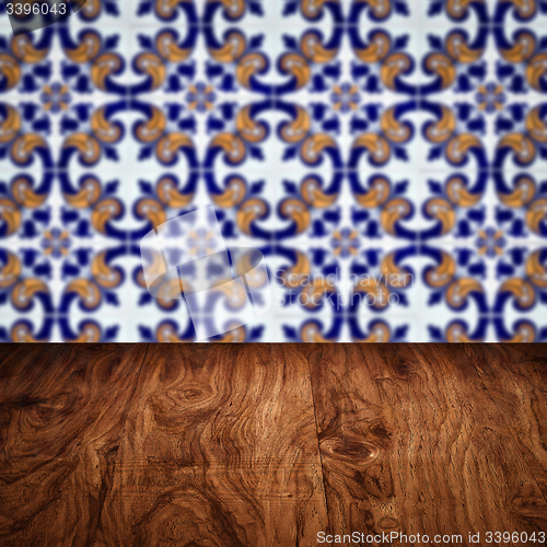 Image of Wood table top and blur vintage ceramic tile pattern wall