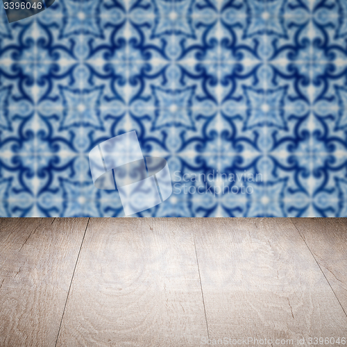 Image of Wood table top and blur vintage ceramic tile pattern wall