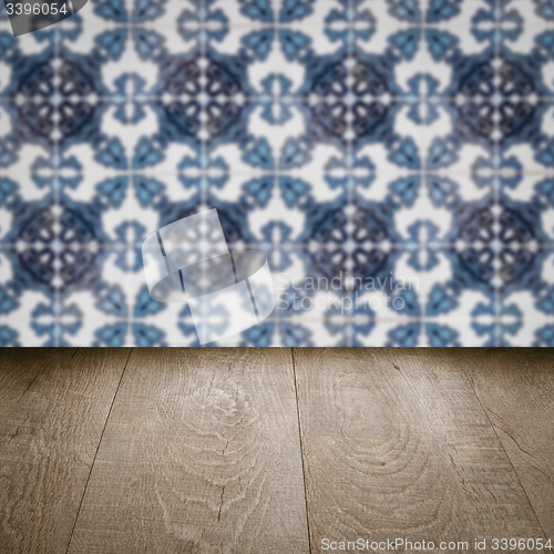 Image of Wood table top and blur vintage ceramic tile pattern wall