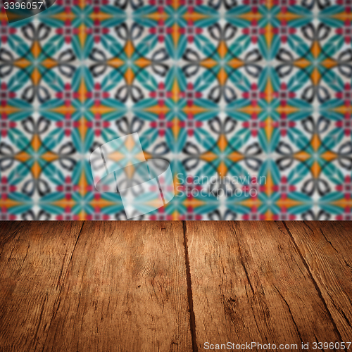 Image of Wood table top and blur vintage ceramic tile pattern wall