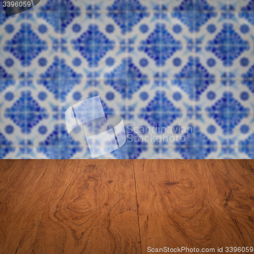 Image of Wood table top and blur vintage ceramic tile pattern wall