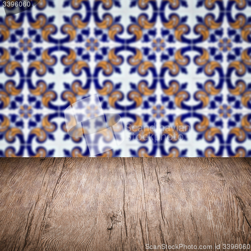 Image of Wood table top and blur vintage ceramic tile pattern wall