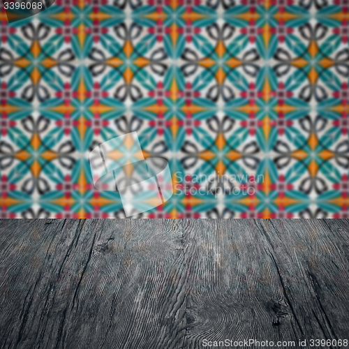 Image of Wood table top and blur vintage ceramic tile pattern wall