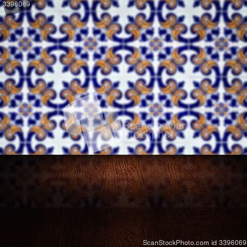 Image of Wood table top and blur vintage ceramic tile pattern wall