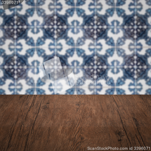Image of Wood table top and blur vintage ceramic tile pattern wall