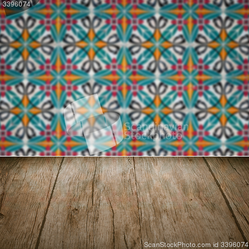 Image of Wood table top and blur vintage ceramic tile pattern wall