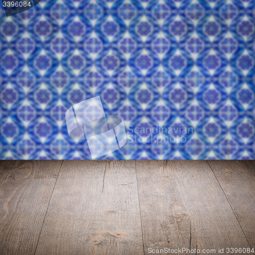 Image of Wood table top and blur vintage ceramic tile pattern wall