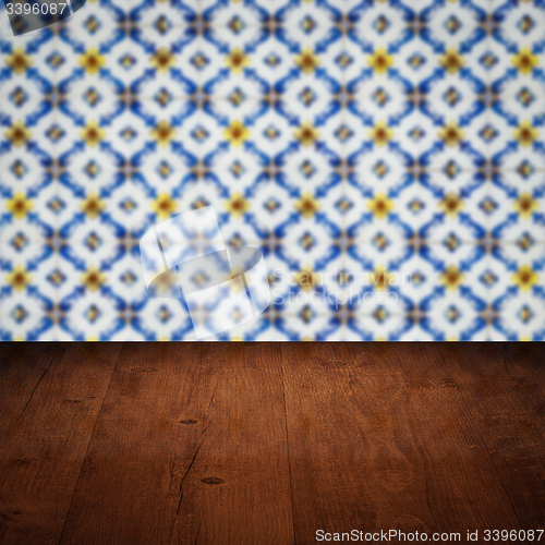 Image of Wood table top and blur vintage ceramic tile pattern wall