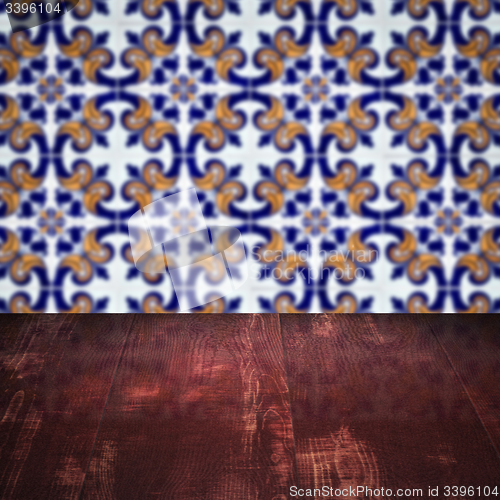 Image of Wood table top and blur vintage ceramic tile pattern wall