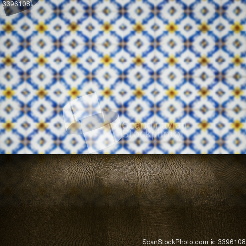 Image of Wood table top and blur vintage ceramic tile pattern wall
