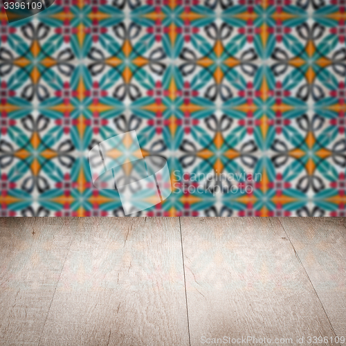 Image of Wood table top and blur vintage ceramic tile pattern wall