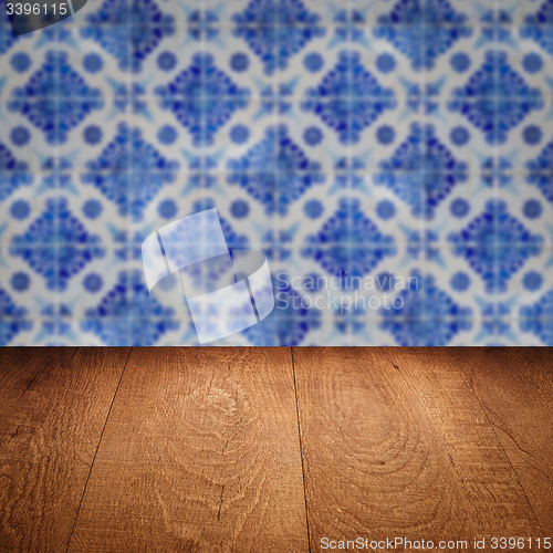 Image of Wood table top and blur vintage ceramic tile pattern wall