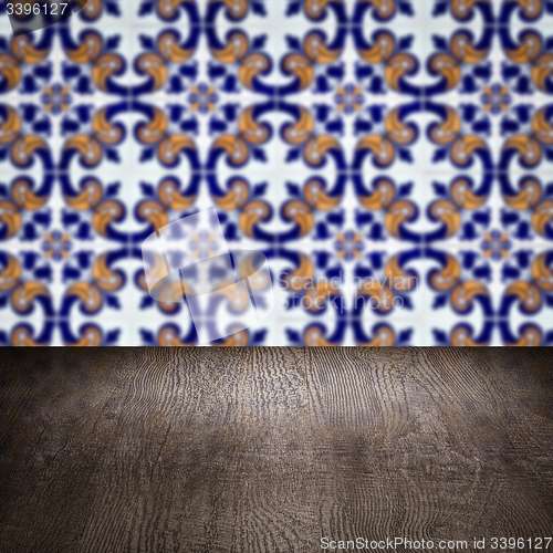 Image of Wood table top and blur vintage ceramic tile pattern wall