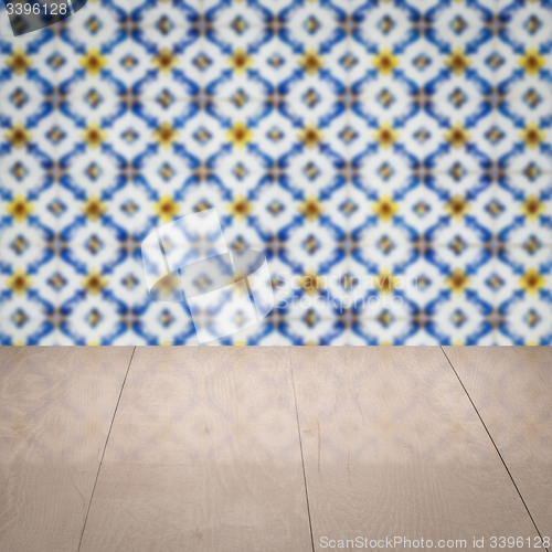 Image of Wood table top and blur vintage ceramic tile pattern wall