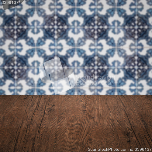 Image of Wood table top and blur vintage ceramic tile pattern wall