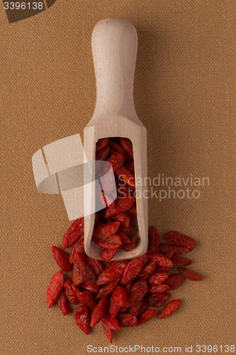 Image of Wooden scoop with dry red goji berries