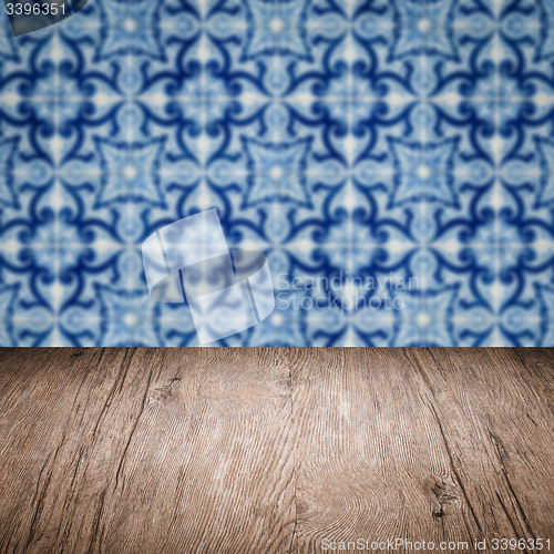 Image of Wood table top and blur vintage ceramic tile pattern wall