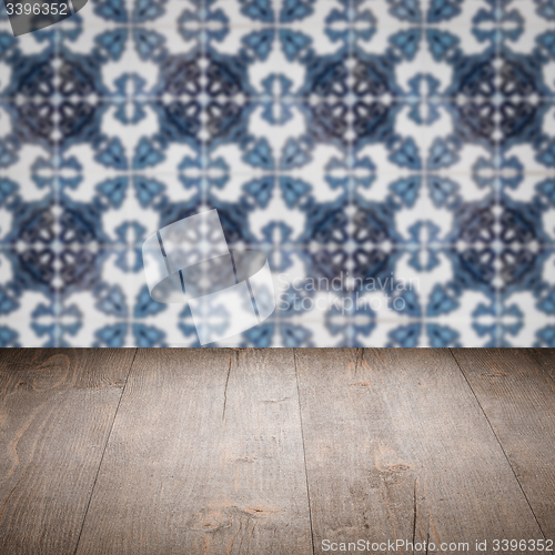 Image of Wood table top and blur vintage ceramic tile pattern wall